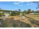 Large backyard with tidy hedges, a young tree and view of home's rear at 6170 7Th N Ave, St Petersburg, FL 33710