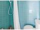 Bathroom with blue tile walls featuring a shower with a white curtain at 6170 7Th N Ave, St Petersburg, FL 33710