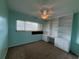 Bedroom with carpeted floors, a ceiling fan, and a built-in desk area with shelves at 6170 7Th N Ave, St Petersburg, FL 33710