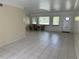 Spacious living room with neutral walls and tile flooring, alongside natural light from multiple windows at 6170 7Th N Ave, St Petersburg, FL 33710