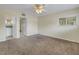 Carpeted main bedroom with a ceiling fan, window, and an ensuite bathroom at 6170 7Th N Ave, St Petersburg, FL 33710