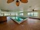 Indoor lap pool with vintage tile flooring, ceiling fans and ample light at 6170 7Th N Ave, St Petersburg, FL 33710