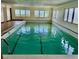 Indoor pool with bright light, clean green water, and tiled surroundings at 6170 7Th N Ave, St Petersburg, FL 33710