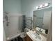 Well-lit bathroom featuring a shower, toilet, sink, and mirror at 6190 107Th N Ave, Pinellas Park, FL 33782