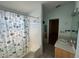 Bathroom with tiled floors, tiled shower/tub, vanity and large mirror at 6190 107Th N Ave, Pinellas Park, FL 33782