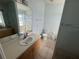 Bathroom with tiled floors, tiled shower/tub, vanity and large mirror at 6190 107Th N Ave, Pinellas Park, FL 33782