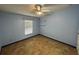 Bright bedroom with ceiling fan, window, tile floors and blue walls at 6190 107Th N Ave, Pinellas Park, FL 33782