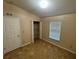 A bedroom shows tile flooring, a large closet and a double-hung window at 6190 107Th N Ave, Pinellas Park, FL 33782
