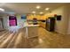 Open-concept kitchen featuring modern stainless steel appliances, light wood cabinets, and breakfast bar at 6190 107Th N Ave, Pinellas Park, FL 33782
