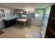 This kitchenette offers black and white cabinets, and a utility sink at 6190 107Th N Ave, Pinellas Park, FL 33782