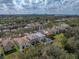 Aerial view of home in neighborhood with mature trees and backyard pool at 6324 Magnolia Trails Ln, Gibsonton, FL 33534