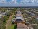 Aerial view of home in neighborhood with mature trees and lawn and solar panels at 6324 Magnolia Trails Ln, Gibsonton, FL 33534