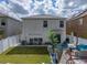 Spacious backyard featuring a well-maintained lawn, a patio, and a white fence at 6324 Magnolia Trails Ln, Gibsonton, FL 33534