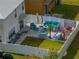 Aerial view of a backyard featuring outdoor seating, a lush lawn, and recreational space at 6324 Magnolia Trails Ln, Gibsonton, FL 33534