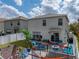 Backyard showcasing a lush lawn, patio area with seating, and a playful ' zone at 6324 Magnolia Trails Ln, Gibsonton, FL 33534