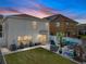 Backyard oasis with a manicured lawn, outdoor seating, and a privacy fence at 6324 Magnolia Trails Ln, Gibsonton, FL 33534