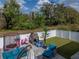 Fenced-in backyard with play equipment, artificial palm, and a covered patio at 6324 Magnolia Trails Ln, Gibsonton, FL 33534