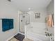 Bathroom with a glass enclosed shower, soaking tub, and tiled floors at 6324 Magnolia Trails Ln, Gibsonton, FL 33534