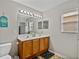 Bathroom featuring double sinks, tile floors, and a window for natural light at 6324 Magnolia Trails Ln, Gibsonton, FL 33534