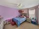 A whimsical bedroom featuring a queen sized bed, carpet floors, and star accents on the ceiling at 6324 Magnolia Trails Ln, Gibsonton, FL 33534