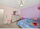 A whimsical bedroom featuring a queen sized bed, carpet floors, and star accents on the ceiling at 6324 Magnolia Trails Ln, Gibsonton, FL 33534