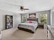Bedroom with a king sized bed, carpet flooring, a ceiling fan and natural lighting at 6324 Magnolia Trails Ln, Gibsonton, FL 33534