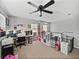 Spacious bonus room features a ceiling fan, carpet flooring, built in desk and plenty of storage at 6324 Magnolia Trails Ln, Gibsonton, FL 33534