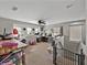 Large bonus room with multiple desks, carpet floors, and a stair case with baby gate at 6324 Magnolia Trails Ln, Gibsonton, FL 33534