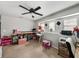 Spacious bonus room featuring a ceiling fan, carpet flooring, built in desk and plenty of storage at 6324 Magnolia Trails Ln, Gibsonton, FL 33534