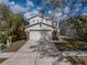 Two-story home with two-car garage, stone accents, and mature landscaping at 6324 Magnolia Trails Ln, Gibsonton, FL 33534