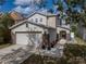 Charming two-story home featuring a two-car garage and stone accents in daylight at 6324 Magnolia Trails Ln, Gibsonton, FL 33534
