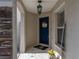 Covered front porch with view of a dark blue front door with wreath at 6324 Magnolia Trails Ln, Gibsonton, FL 33534