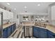 Well-lit kitchen with blue cabinets, a stainless steel dishwasher and an open layout at 6324 Magnolia Trails Ln, Gibsonton, FL 33534
