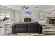 Bright living area with wood-look floors, a large screen TV, and plenty of seating for guests at 6324 Magnolia Trails Ln, Gibsonton, FL 33534