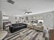 Spacious living area featuring hardwood floors, neutral decor, and an open layout for entertaining at 6324 Magnolia Trails Ln, Gibsonton, FL 33534