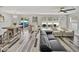 Open-concept living space featuring wood-look floors, neutral decor, and backyard views at 6324 Magnolia Trails Ln, Gibsonton, FL 33534