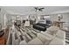 Open-concept living space featuring wood-look floors and easy access to other areas of the home at 6324 Magnolia Trails Ln, Gibsonton, FL 33534