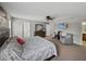 Open main bedroom with a ceiling fan, gray walls, and carpeted floors at 6324 Magnolia Trails Ln, Gibsonton, FL 33534