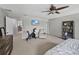 Bright and airy main bedroom with a sitting area and a modern ceiling fan at 6324 Magnolia Trails Ln, Gibsonton, FL 33534