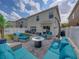 Charming backyard patio features cozy lounge seating, fire pit, and lush green lawn at 6324 Magnolia Trails Ln, Gibsonton, FL 33534