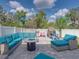 Entertaining patio featuring stylish seating, fire pit, and play area for , creating a fun backyard oasis at 6324 Magnolia Trails Ln, Gibsonton, FL 33534