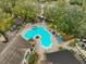 Aerial view of the community pool and common areas with sun deck, landscaping, and nearby buildings at 8609 Mallard Reserve Dr # 103, Tampa, FL 33614