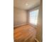 Bedroom featuring hardwood floors and a large window that provides natural light at 8609 Mallard Reserve Dr # 103, Tampa, FL 33614