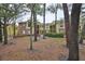 Apartment building exterior with mature trees and landscaping in the foreground at 8609 Mallard Reserve Dr # 103, Tampa, FL 33614