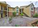 Yellow condo building featuring brick accents and landscaped courtyard at 8609 Mallard Reserve Dr # 103, Tampa, FL 33614