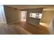 Light-filled living room featuring hardwood floors and an open floor plan leading into the kitchen at 8609 Mallard Reserve Dr # 103, Tampa, FL 33614