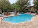Large community pool with sun deck, landscaping, and nearby common areas with outdoor furniture at 8609 Mallard Reserve Dr # 103, Tampa, FL 33614