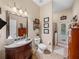 Bright bathroom with granite vanity, toilet, shower and glass door with exterior access at 1111 Carriage Park Dr, Valrico, FL 33594