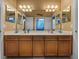 Bright bathroom with a double sink vanity, framed mirrors, and beach-themed decorations at 1111 Carriage Park Dr, Valrico, FL 33594
