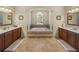 Elegant bathroom with double vanity, a soaking tub set in an alcove, and tile flooring at 1111 Carriage Park Dr, Valrico, FL 33594
